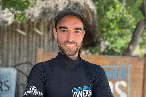 Meet the Spanish Dancer Divers team member in Zanzibar, smiling outdoors.