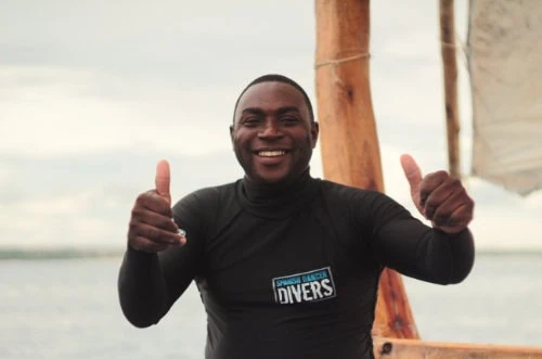 Smiling diving instructor giving thumbs up at Spanish Dancer Divers Zanzibar.